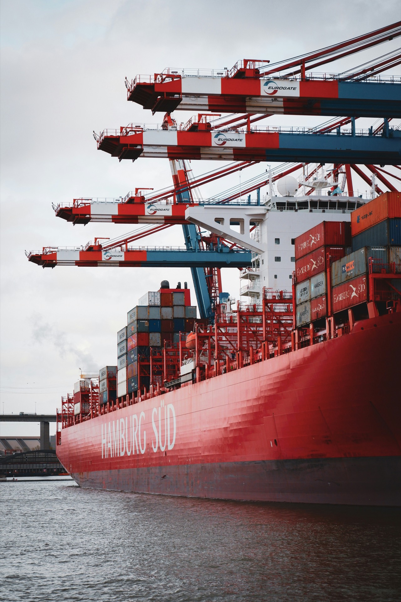 Container vessel being loaded at port